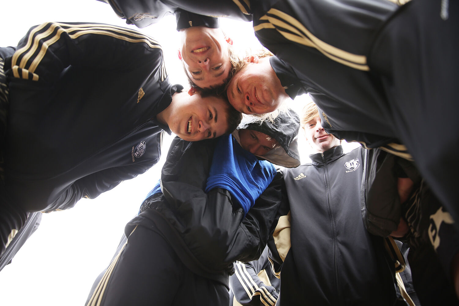 Boys soccer huddled tight together during halftime